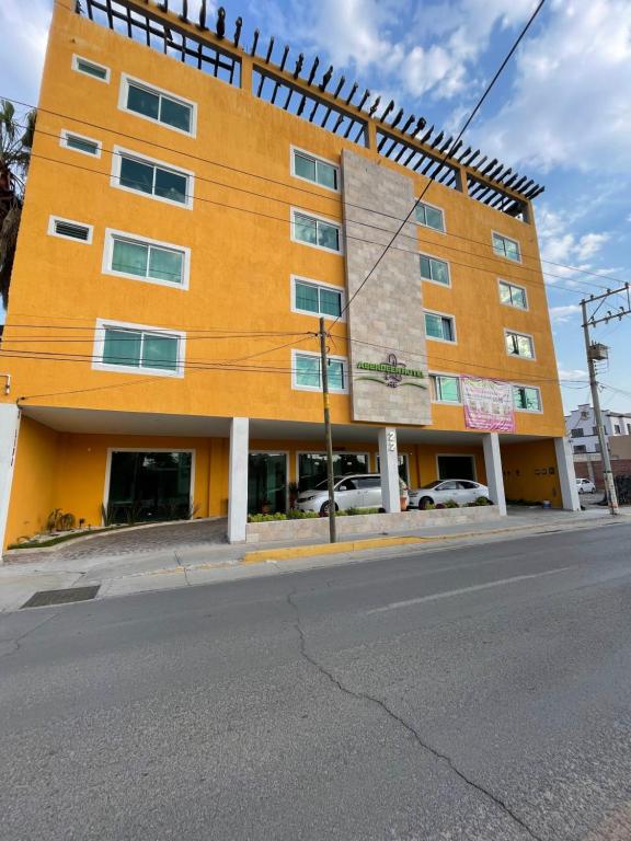 多洛雷斯-伊达尔戈ABERDEEN HOTEL DOLORES HIDALGO的街道拐角处的橙色建筑