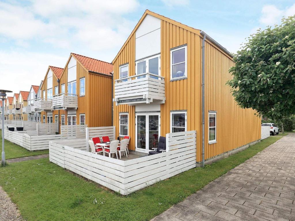 鲁德克丙4 person holiday home in Rudk bing的一排白色和橙色的房屋
