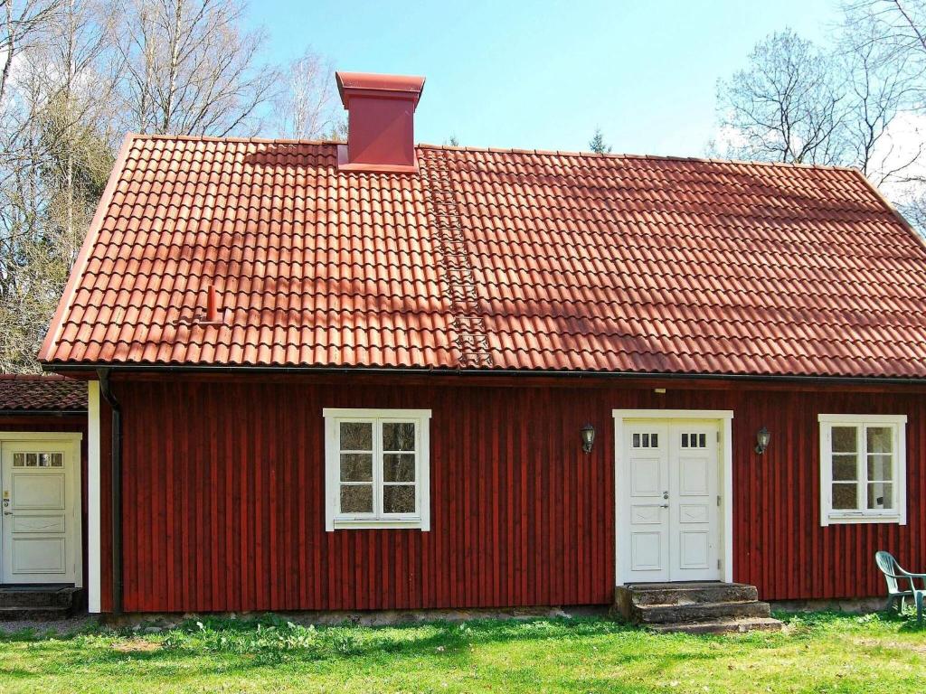 VankivaHoliday home VANKIVA的红色的房子,有白色门和红色屋顶