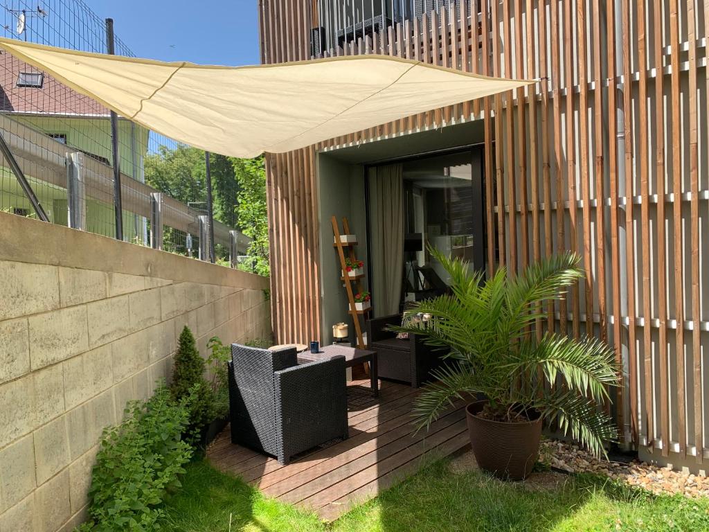 多克西Jezerní apartmán s terasou a saunou v Lakepark Residence的一座建筑中带遮阳伞的庭院