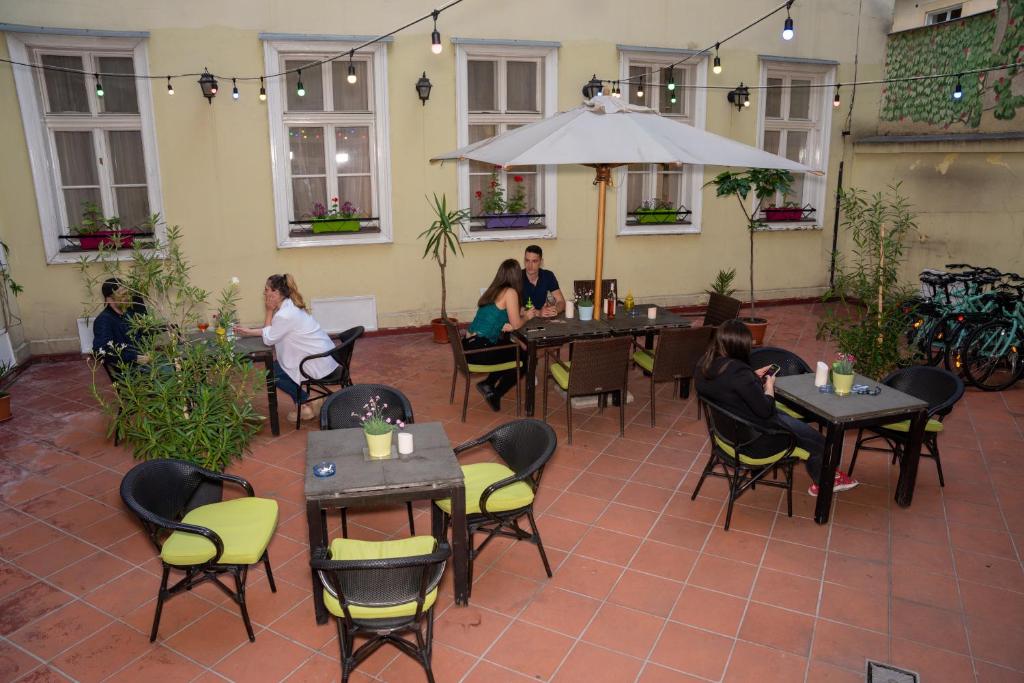 布达佩斯MP Hostel Budapest的一群坐在餐厅桌子上的人