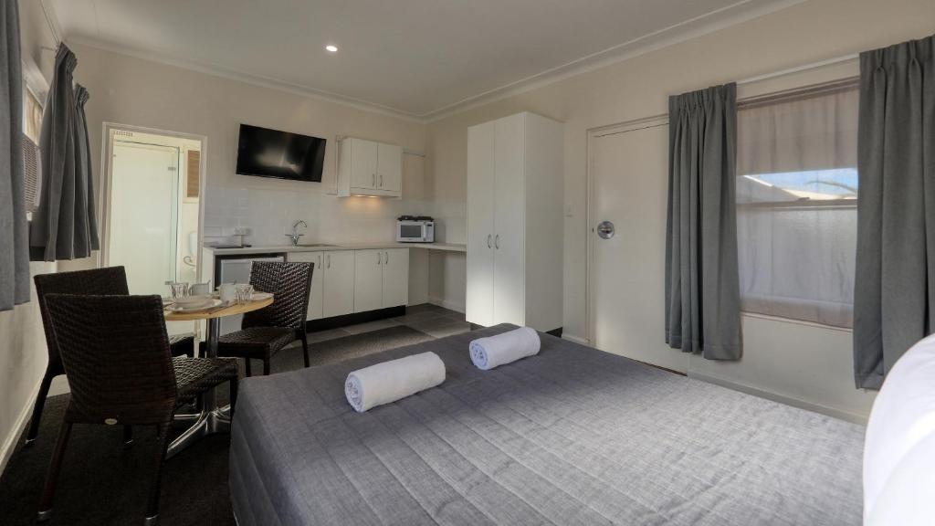 考拉考拉汽车旅馆 的一间卧室配有一张床铺和一张桌子,还设有一间厨房