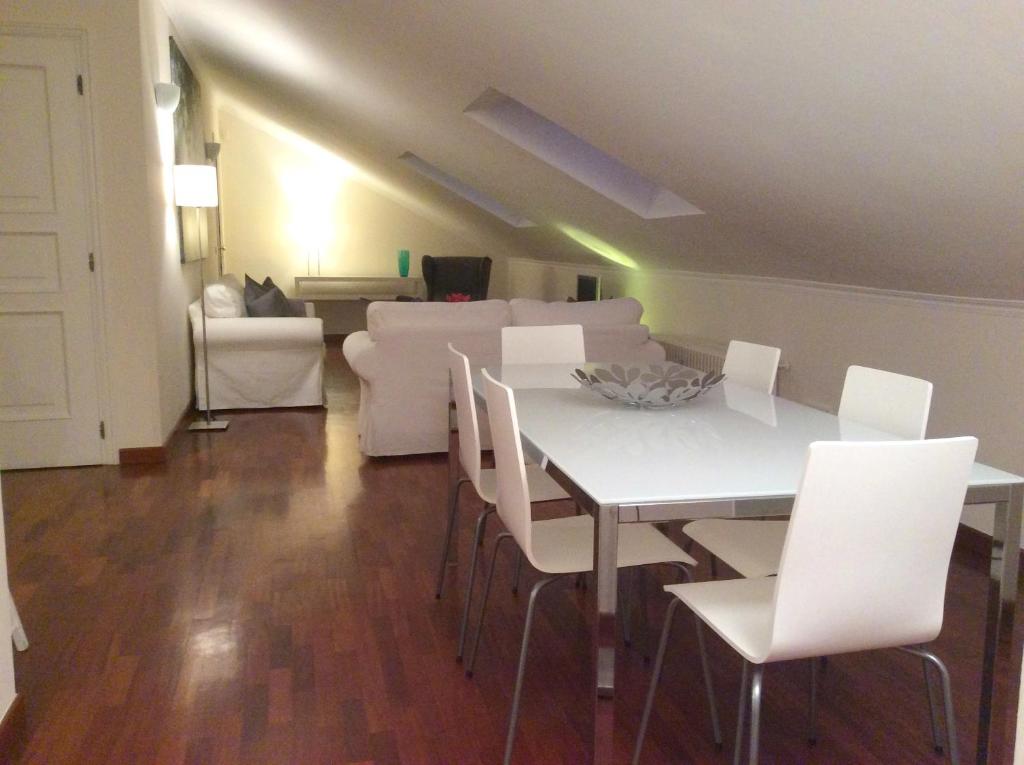 阿尔巴Apartment La Mansarda的客厅配有白色的桌子和白色的椅子