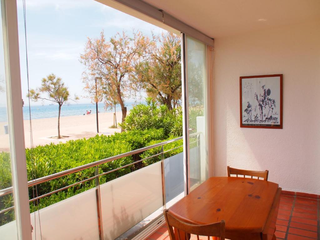 罗萨斯LA PLAGE 4B的一间设有桌子并享有海滩美景的用餐室