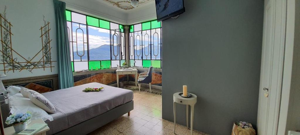 卡尼洛瑞维拉Hotel La Rondinella的一间卧室设有床铺和彩色玻璃窗