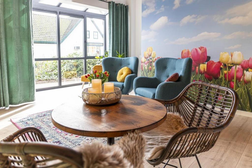西姆斯科克Bed & Breakfast Bakker Meijer的客厅配有桌椅和郁金香