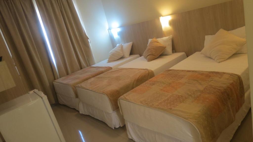 萨尔托德尔瓜塔库茹精品酒店的两间带两张床的酒店客房