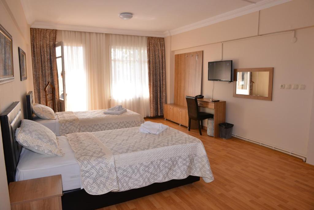 伊斯坦布尔爱慕萨奥特尔马尔特艾文斯公寓的酒店客房设有两张床和电视。
