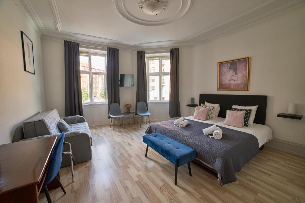 哥本哈根阿迈厄岛酒店的一间卧室配有一张大床和一张桌子及椅子