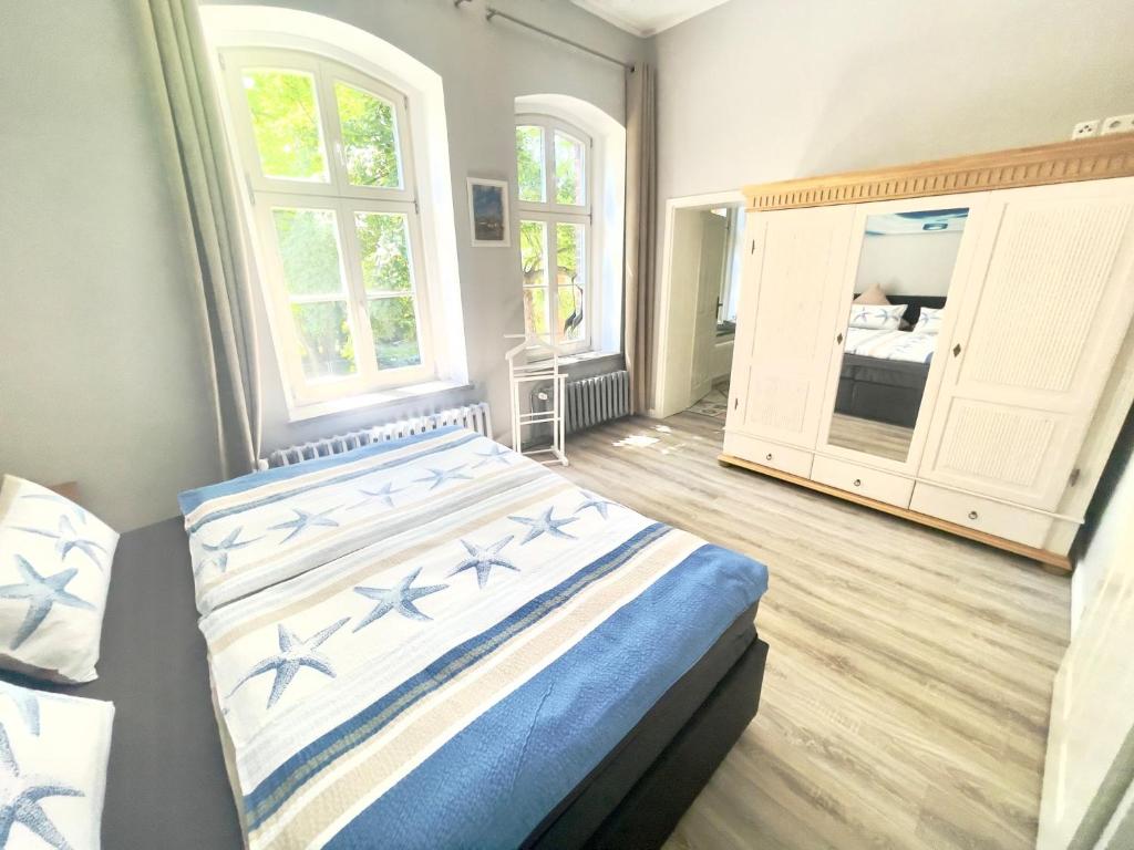 施特拉尔松德Gästehaus Sternschanze - App5 Leichtmatrose的一间卧室设有一张床和一个大窗户