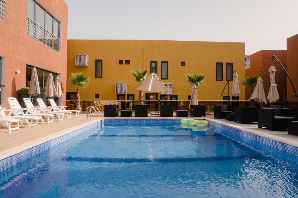 努瓦克肖特Marrakech - Premium Suite的游泳池,带椅子和遮阳伞