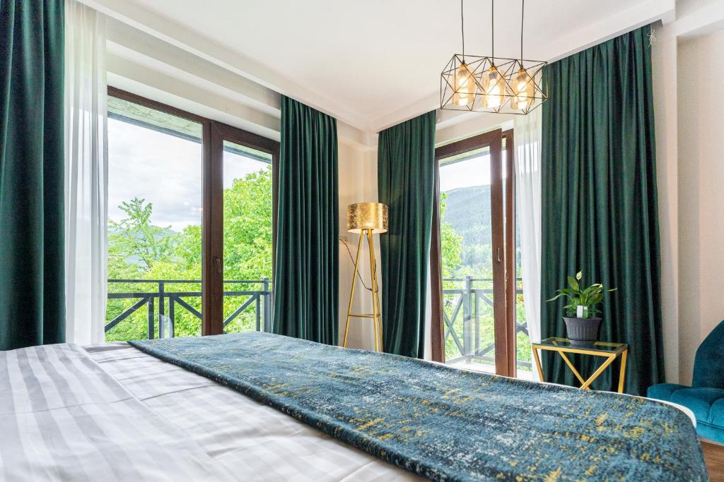梅斯蒂亚Hotel Chatini Mestia的一间卧室设有一张大床和大窗户