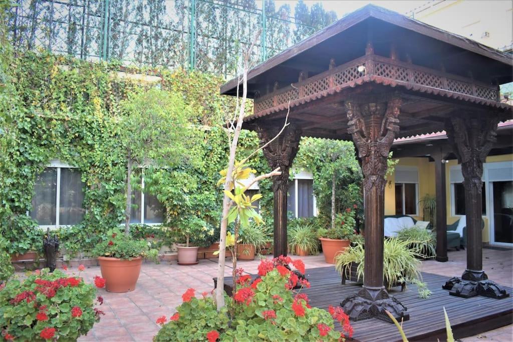 萨拉戈萨Casa con terrazas的庭院内带鲜花的木制凉亭