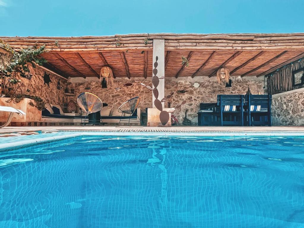Ghazoua达马查酒店的石头建筑前的游泳池