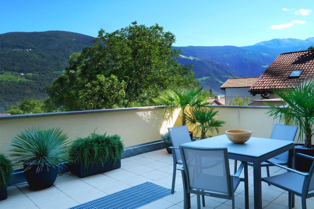 帕尔奇内斯Apartment Cascada的阳台配有桌椅,享有山景。
