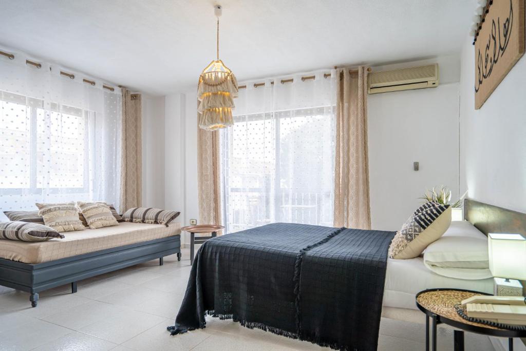 洛斯阿尔卡萨雷斯拿勒赫斯酒店的一间卧室配有一张床、一张沙发和窗户。