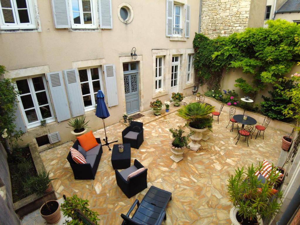 沙托鲁Maison d'hôtes de charme - Au Lys Blanc的户外庭院配有家具和桌椅