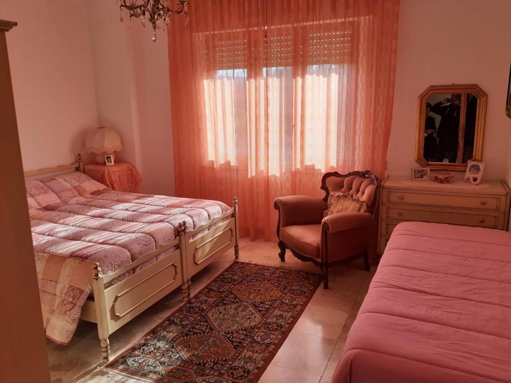 皮希纳斯B&B ANNA的一间卧室配有两张床、一把椅子和镜子