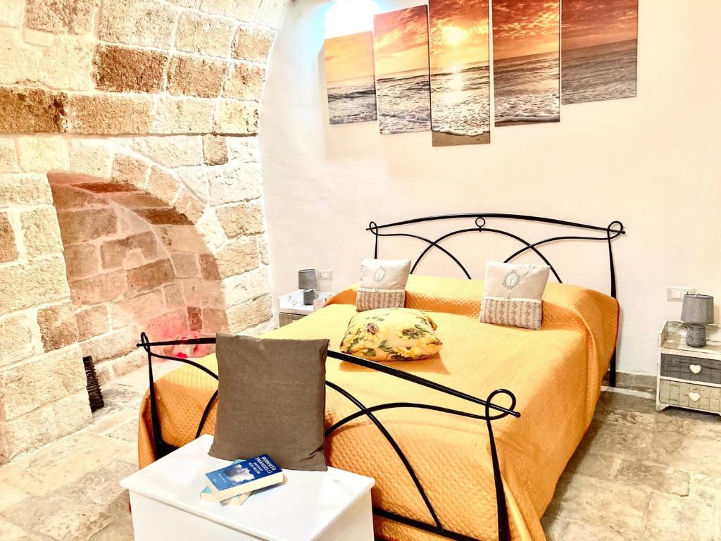滨海波利尼亚诺Antica Pietra的一间卧室设有一张床和石墙
