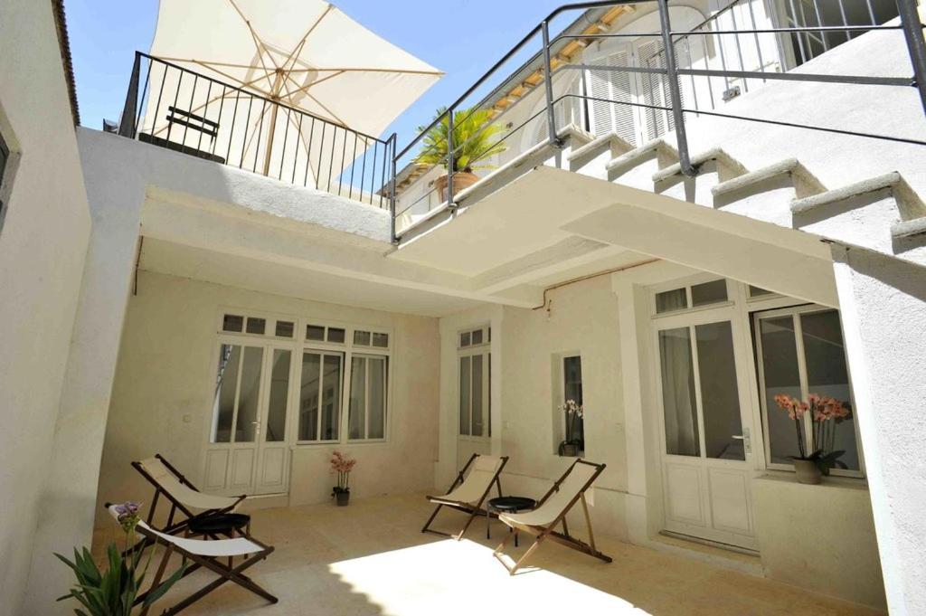 阿维尼翁Maison Boussingault的一个带椅子的庭院和一个带楼梯的阳台