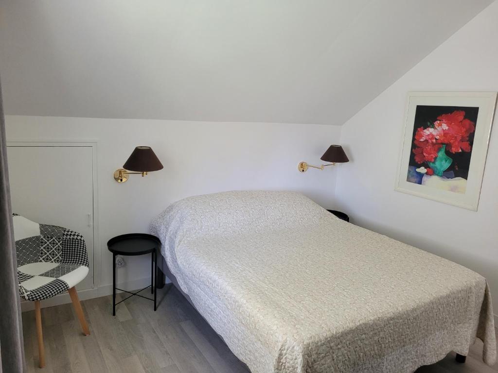 圣提里耶拉佩尔什La maison d'Hera的白色卧室配有床和椅子