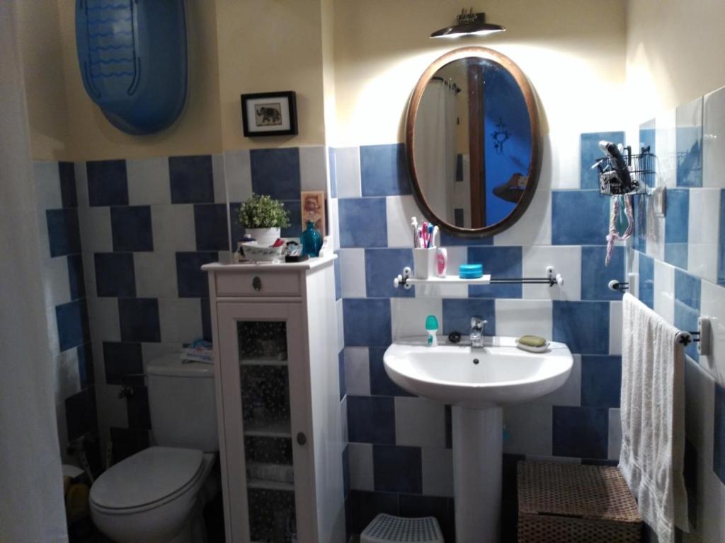 莱图尔Casa Rural la Escalera的一间带水槽、卫生间和镜子的浴室