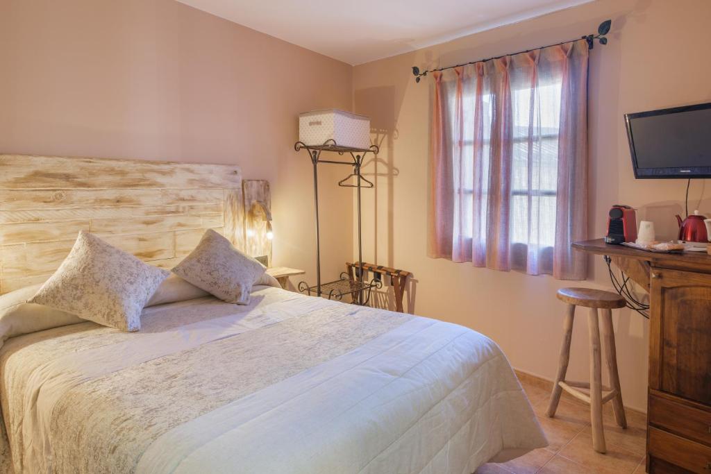 毕斯卡斯El Rincón de Andrea Habitaciones的一间卧室设有一张大床和一个窗户。