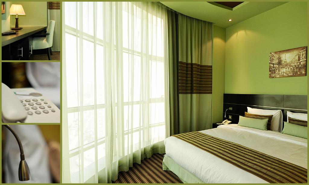 沙迦阿达尔酒店的一间卧室设有一张床和一个大窗户