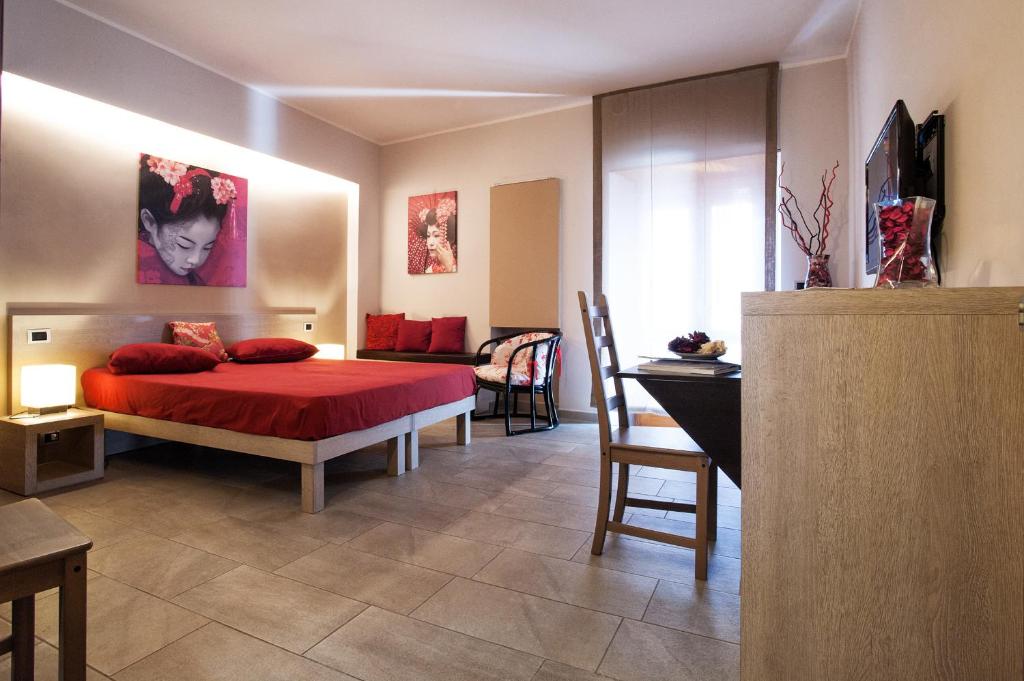 巴列塔艾尔桑特罗罗斯托里科住宿加早餐酒店的一间卧室配有一张红色床罩的床