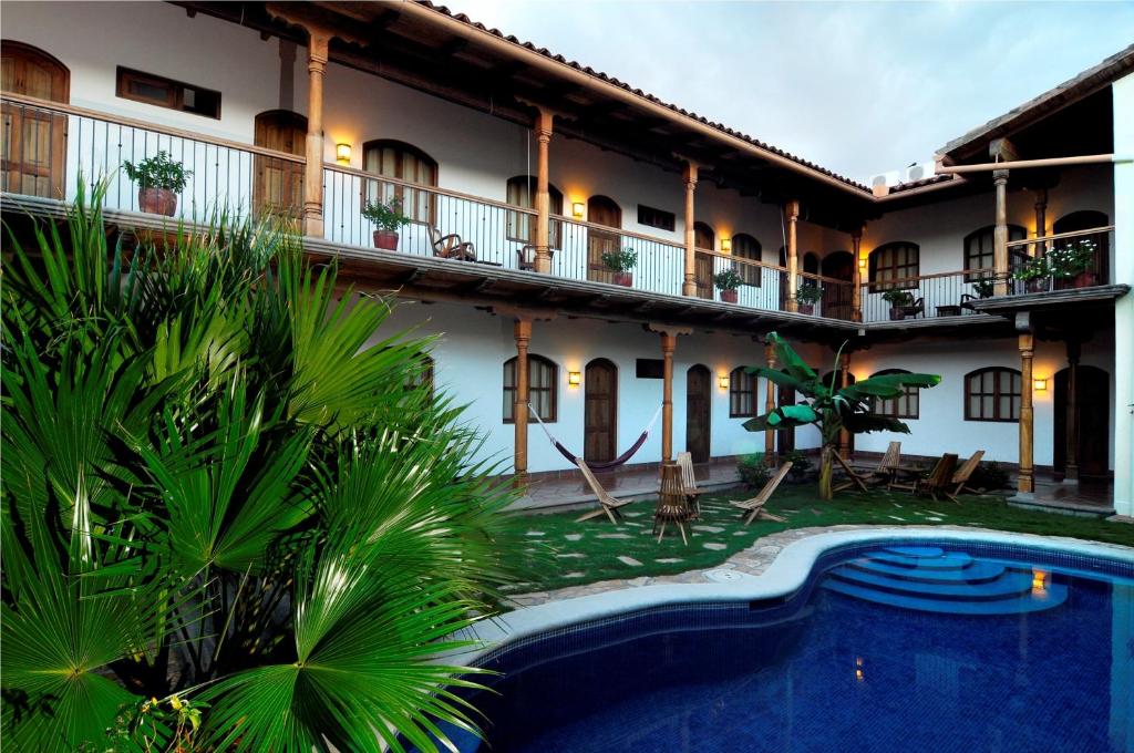 格拉纳达Hotel Patio del Malinche的大楼前设有游泳池的酒店