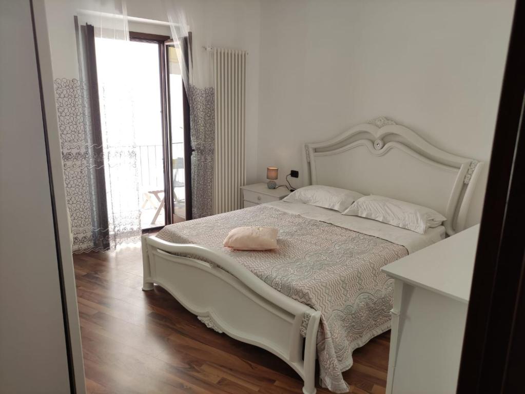 维耶斯泰Uria Rooms & Suite B&B的卧室配有白色的床和粉红色枕头
