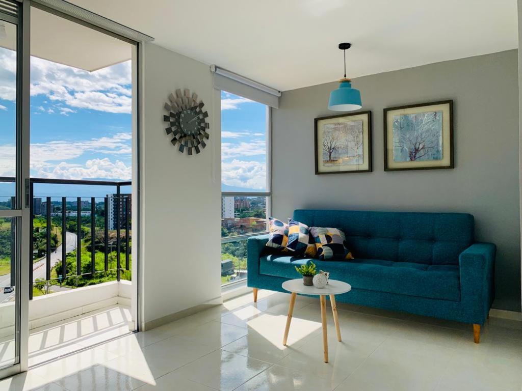 佩雷拉Espectacular apartamento completo en Pereira的客厅配有蓝色的沙发和桌子