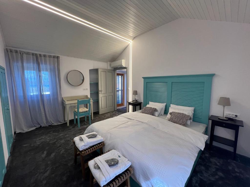 内里吉恩Podgora Experience Suite with jacuzzi的一间卧室配有一张大床和蓝色床头板