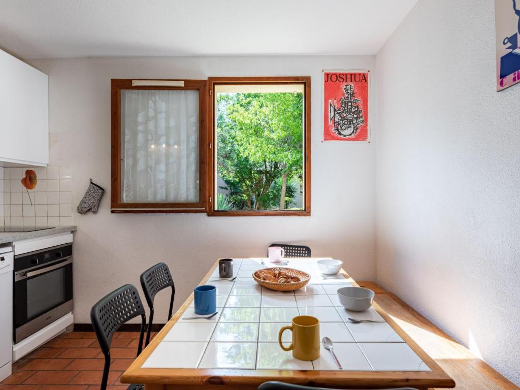 拉卡诺奥肯Holiday Home Les Landaises-9 by Interhome的厨房配有桌椅和窗户。