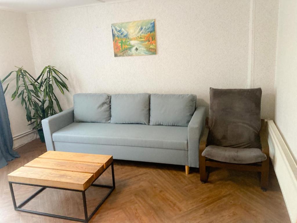 奥格雷Apartaments Ogre.的客厅配有蓝色的沙发和椅子