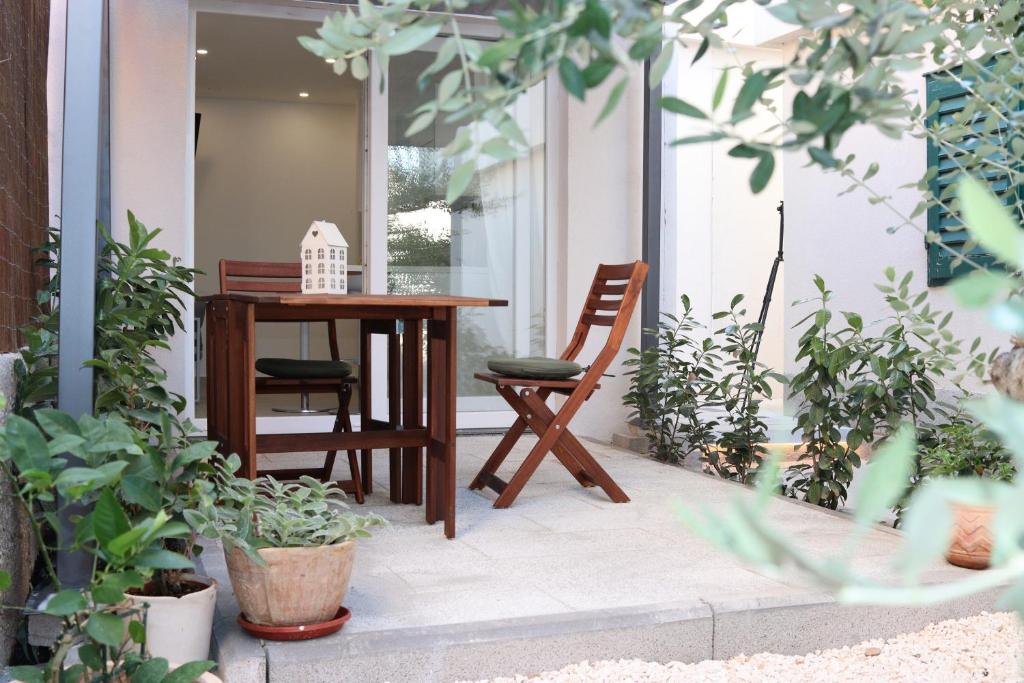 希贝尼克Lovely Suite的种植了植物的门廊上的桌椅