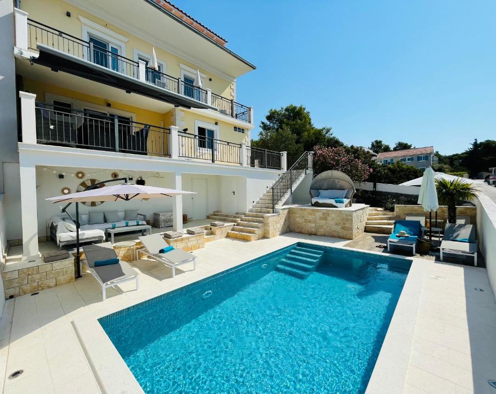 马斯林尼察Villa Lemony的一座带游泳池和房子的别墅