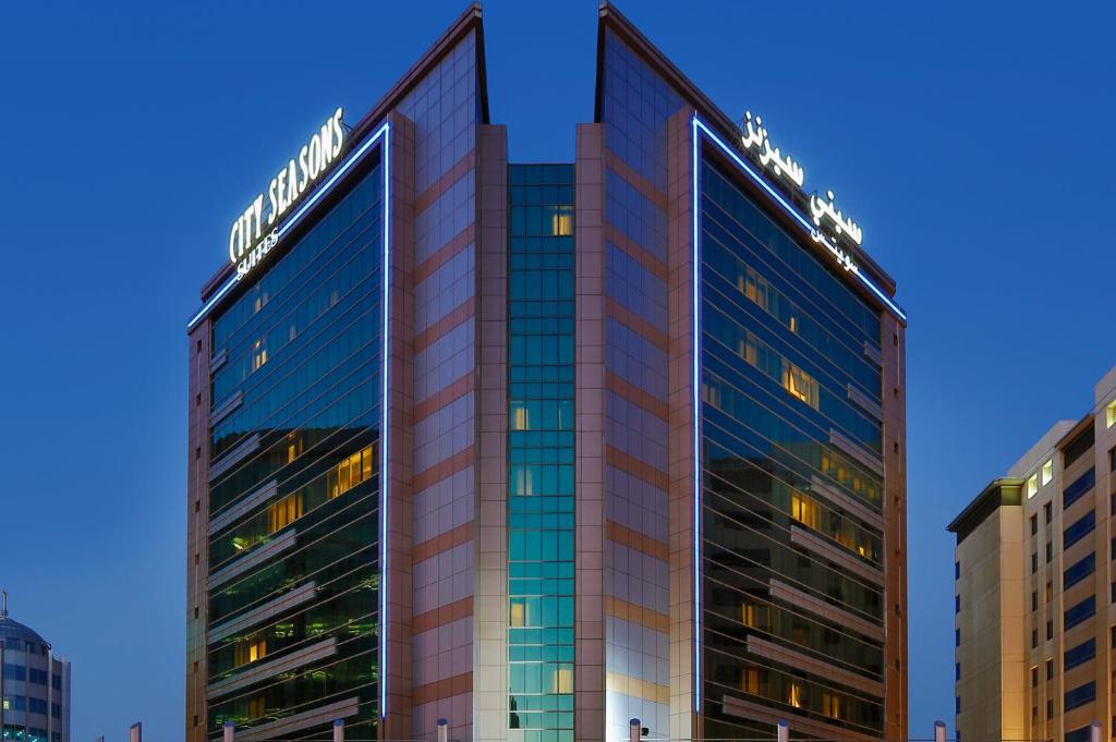 迪拜City Seasons Suites的一座高大的建筑,上面有标志