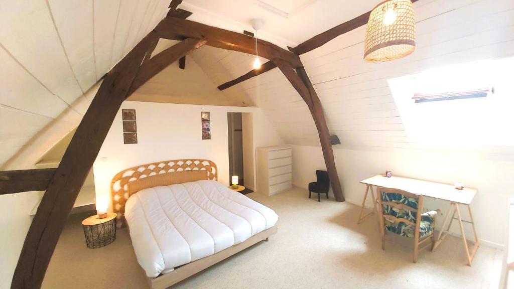 希农La Maison de Louise Chinon #chateaux #vignobles的阁楼上一间卧室配有床和书桌