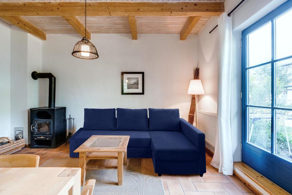 朗克维茨4-Raum Apartment bis 8 Pers 43的客厅配有蓝色的沙发和炉灶。
