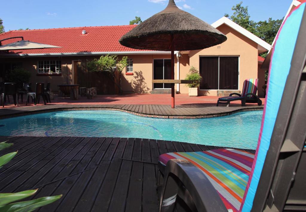 范德拜尔帕克奥尔温斯旅馆的一个带冲浪板和遮阳伞的游泳池