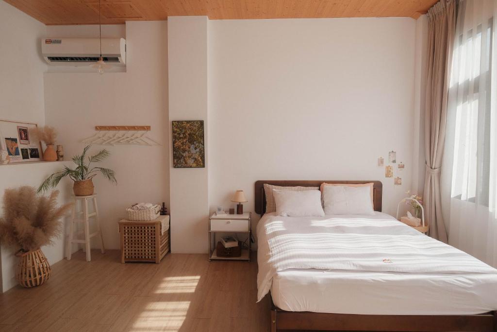 台南 私所 Privacy 的卧室配有白色的床和窗户。