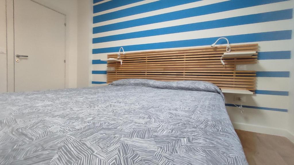 西尼加利亚Casa Vacanze "Machí"的一间卧室配有一张床和条纹墙
