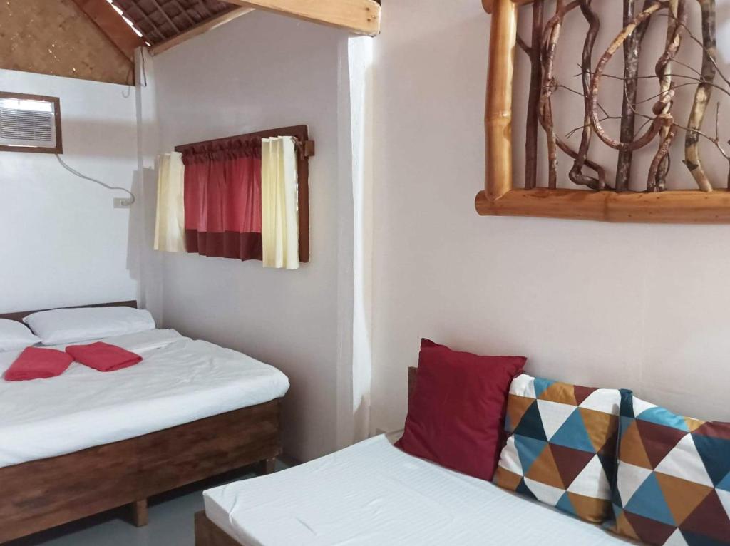 布桑加OcamOcam Azur Inn的一间设有两张床和一张沙发的房间
