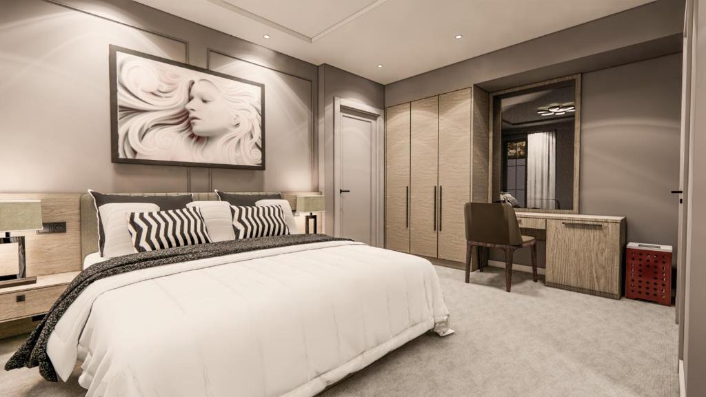 爱尔巴桑Hotel Golden的卧室配有一张白色大床和一张书桌