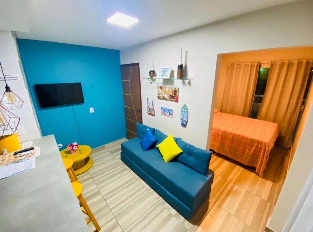 嘎林海斯港Studio A completo 400m da praia的客厅配有蓝色的沙发和床。
