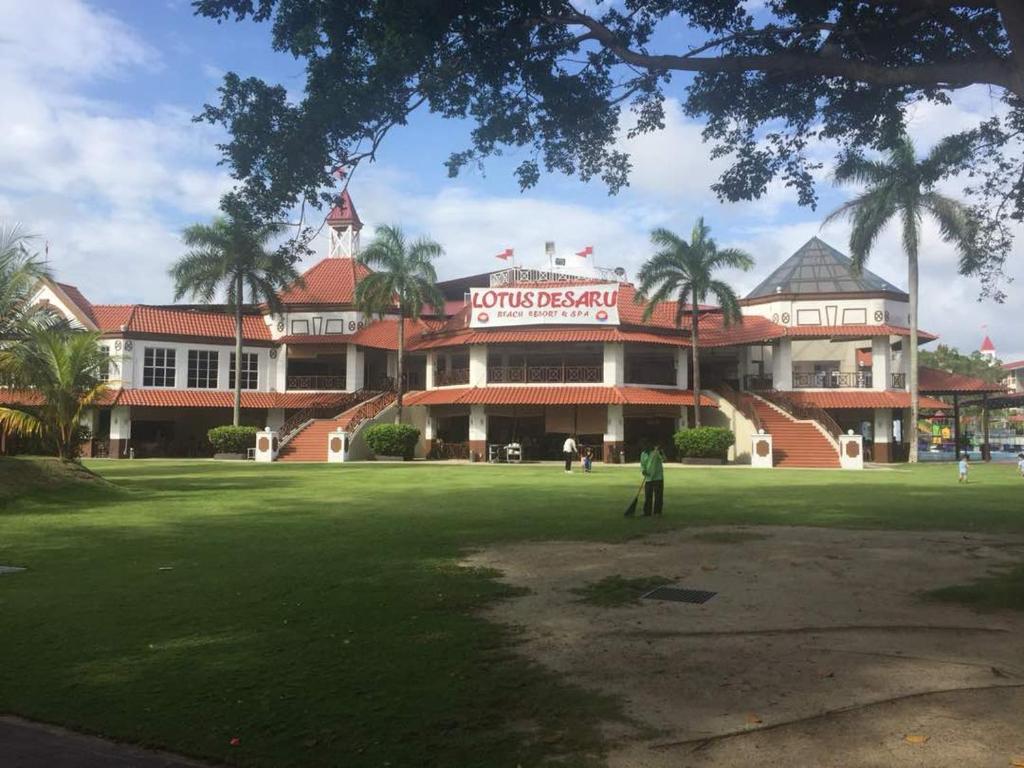 迪沙鲁D'Vista Residenz in Lotus Desaru Beach Resort的站在一座大建筑前面的人