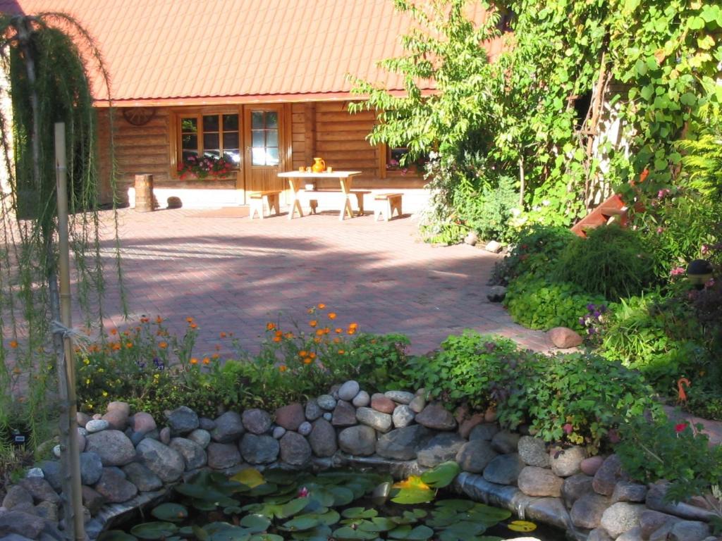 凯卡瓦自治市Brīvdienu māja Mētriņi的一个带桌子和花池的花园
