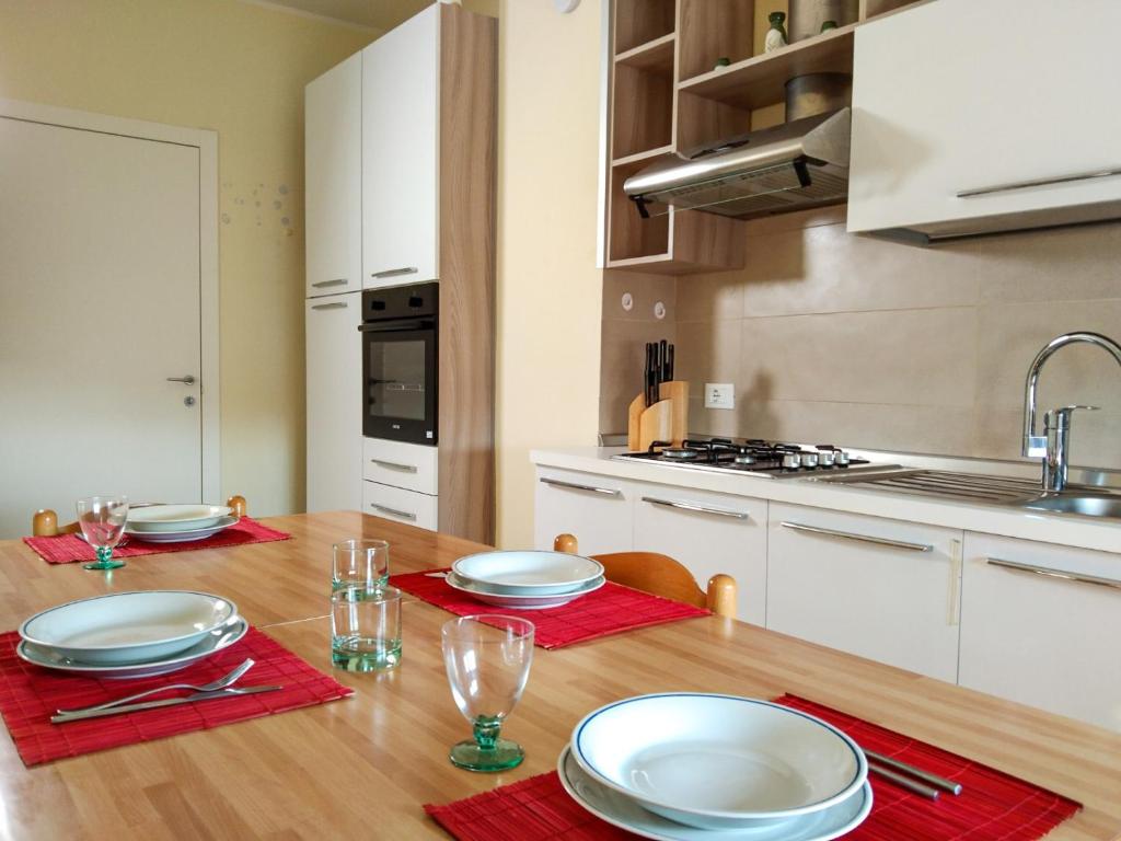 摩德纳Casa Bignardi - Affitti Brevi Italia的厨房配有木桌和盘子