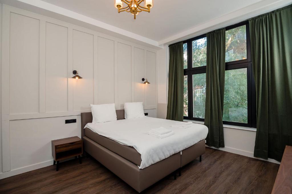 鹿特丹Mr.Lewis Rotterdam的一间卧室设有一张床和一个大窗户